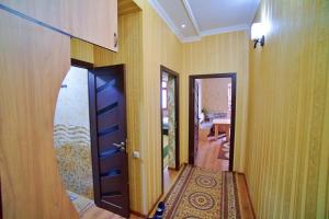 a hallway with a door and a room with a rug at one-room apartment in Dushanbe in Dushanbe