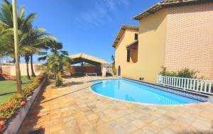 a swimming pool in front of a house at Casa vista mar in Aracaju