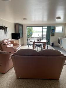 a living room with a couch and a table at Breeze Inn in Parua Bay
