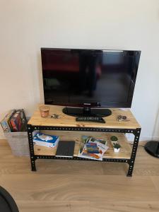 a tv sitting on top of a wooden table at Studio chez Cylène in Laruns