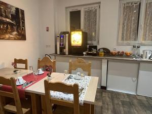 a dining room with a table and a kitchen with a table and chairs at Albert 1er in Albertville