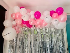 a cluster of pink and white balloons and silver columns at Driftaway on Dundas in Rye