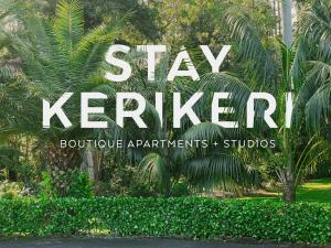 a sign that says stay keefer in a garden at Stay Kerikeri in Kerikeri