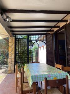 a table and chairs on a patio at Villa Hidra near Cefalù in Buonfornello