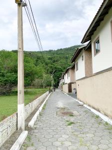 a cobblestone street next to a house and a pole at Studio Tranquilo in Florianópolis