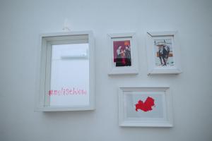 a group of pictures on a wall with a window at Dimora Pardo in Larino