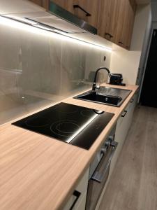 a kitchen with a sink and a stove at Olive-Luxury apartment in agrinio in Agrinion