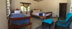 A bed or beds in a room at Yawekata Eco Still Bluewater Resort