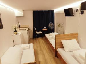 a small room with two beds and a table at Sylhet BNB in Lisbon
