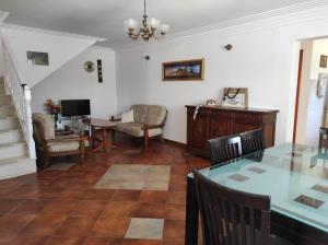 a living room with a table and chairs and a television at Vila Šeki in Bar