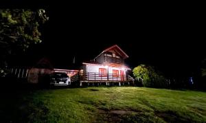 a house with a car parked in front of it at night at Tu Parcela en Carretera Austral in Hualaihué