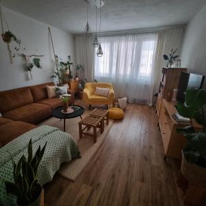ein Wohnzimmer mit einem Sofa und einem Tisch in der Unterkunft Slnečná oáza pokoja in Partizánske