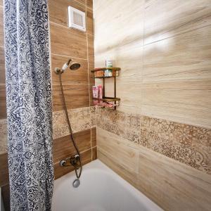 a bathroom with a shower with a shower curtain at Slnečná oáza pokoja in Partizánske