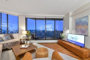 a living room with a large flat screen tv at Skyview Executive Stay in Victoria