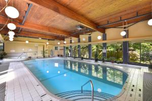 a large swimming pool in a large building with a large at Skyview Executive Stay in Victoria