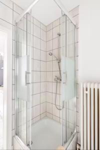 a shower with a glass door in a bathroom at 1Zimmer, Küche, Bad, EG Fewo Rupertsberg in Sankt Georgen im Schwarzwald
