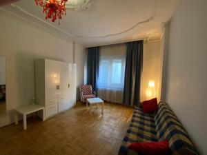a living room with a couch and a chair at Apartment with Balcony and AC next to Danube in Budapest