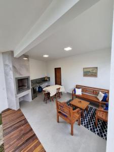 a living room with wooden furniture and a table at Casa Mar in Armacao dos Buzios +29 photos