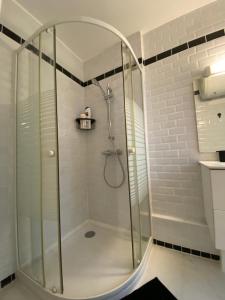a shower with a glass door in a bathroom at L'industriel in Ablis