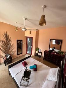 a bedroom with a white bed in a room at Stardust Villa - ** Hotel in Paje