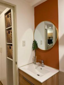 a bathroom with a sink and a mirror at Luxury 1 BR Suite Near NAIA in Manila