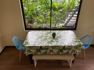 a table with a table cloth on it with a window at Casa Jaguar Tortuguero in Tortuguero