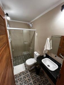 a bathroom with a shower and a toilet and a sink at Casarão 47 in Areia