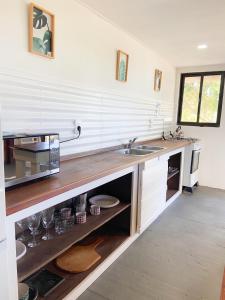 a kitchen with a sink and a counter at Mandalas de Mar in Punta Del Diablo