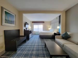 a hotel room with a bed and a couch at Holiday Inn - Belcamp - Aberdeen Area, an IHG Hotel in Belcamp