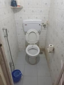 a small bathroom with a toilet in a stall at Private Farm Stay in Pune +25 photos