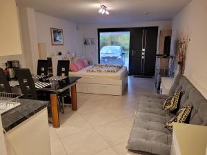 a living room with a couch and a table at Modernes Appartement Mia in Dätzingen