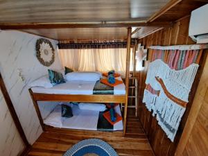 a small room with two beds in a cabin at Tour komodo in Labuan Bajo