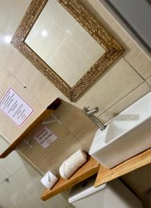 a bathroom with a sink and a mirror at Casa 02 na villa uryah in Caraíva