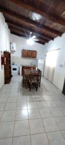 a kitchen with a table and a kitchen with a stove at Cabaña Nde Roga in Colonia Carlos Pellegrini