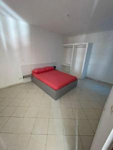 ein kleines Schlafzimmer mit einem roten Bett in einem Zimmer in der Unterkunft Casa Cor de Rosa in Praia