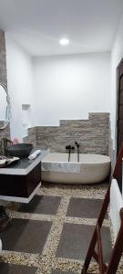 a bathroom with a bath tub and a sink at Carpe Diem Villas & Resort in Puerto Princesa City