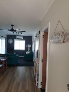 a living room with a couch and a table at Lisianna Apartments in Hervey Bay