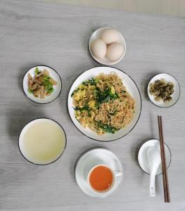 a table with plates of food with eggs and other ingredients at Olioinn B&B in Wenchang