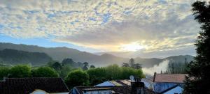 a view of the sun rising over the mountains at Penthouse Furnas in Furnas