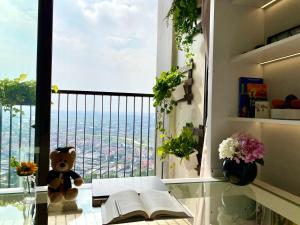 a room with a window with a teddy bear and books at Ecopark Happy Haven in HÆ°ng YÃªn