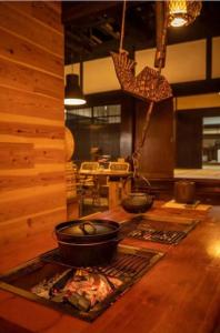 古民家さくらや في أتامي: مطبخ مع قدور ومقالي على موقد