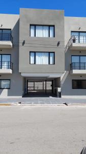 a large building with a lot of windows at Departamentos del Trébol in Necochea +70 photos