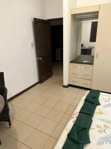 a room with a bed and a kitchen with a counter at Ambitious Apartment Lot 7 in Nadi