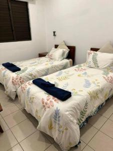 two beds sitting next to each other in a room at Ambitious Apartment Lot 7 in Nadi