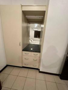 a bathroom with a closet with a sink in it at Ambitious Apartment Lot 7 in Nadi