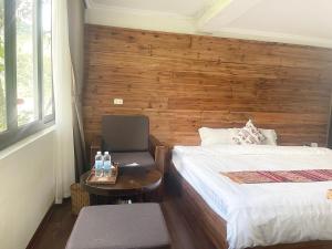 מיטה או מיטות בחדר ב-Sapa Village Hotel