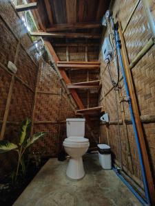 a bathroom with a toilet in a building at Wonderland in Siquijor