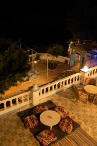 a patio with a table and a fence at night at Nubian Beach - حسن فوكس in Aswan