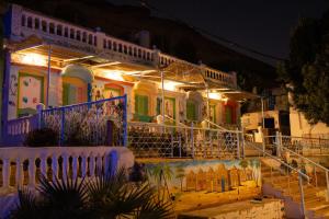 a house lit up at night with lights at Nubian Beach - حسن فوكس in Aswan