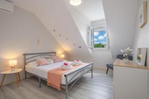 a bedroom with a bed with two dolls on it at Villa Kay Lakansiel, magnifique cocon familial avec piscine in Le Vauclin